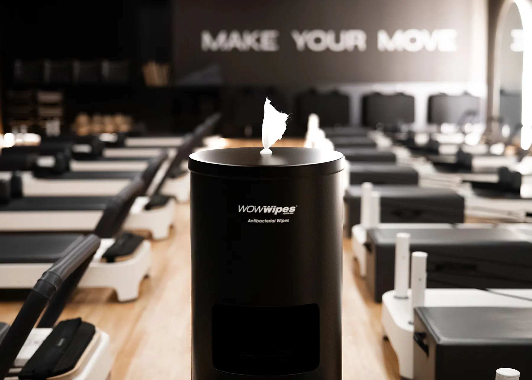 Black wet wipes dispenser in a reformer pilate studio
